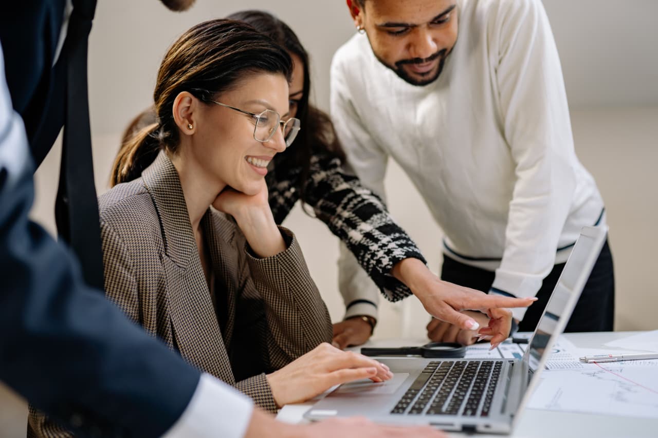 Two colleagues reviewing an interface together on a laptop